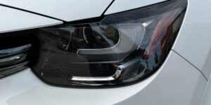 Closeup of a headlight on a white car
