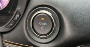 A close up of a car starter power button