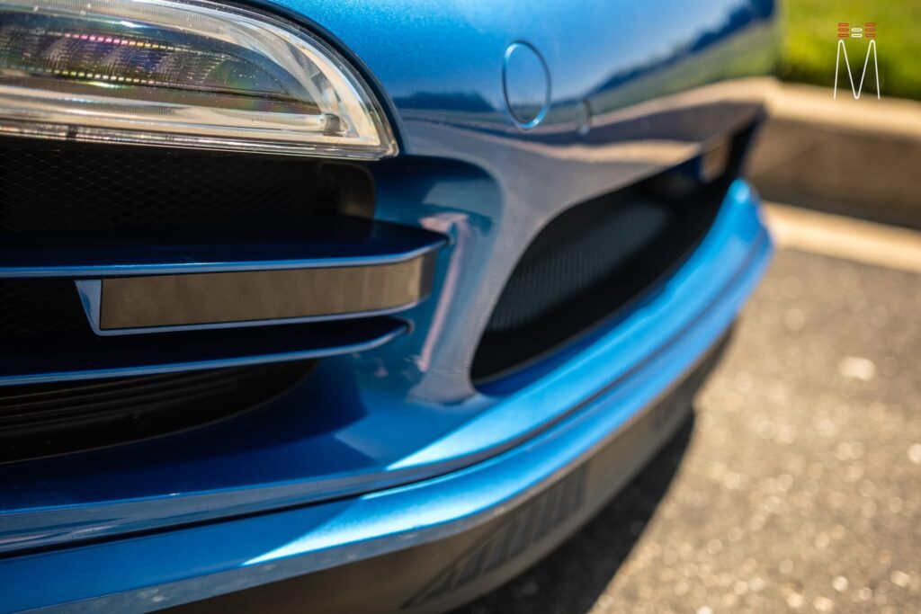 Close up of the front fender of a blue car